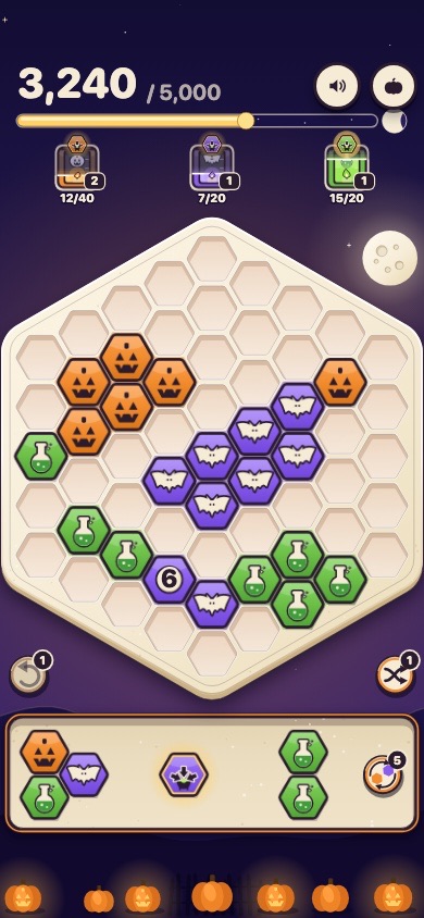 Scraps on a phone in its Halloween look: a hex tile board with pumpkin, bat and potion tiles