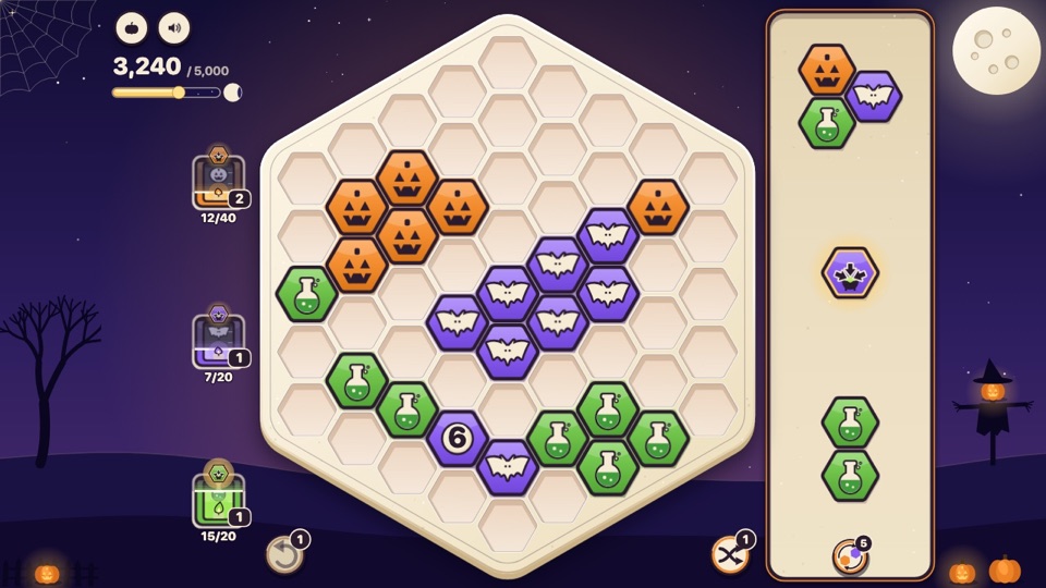 Scraps in its Halloween look: a hex tile puzzle mid-game with pumpkin, bat and potion tiles
